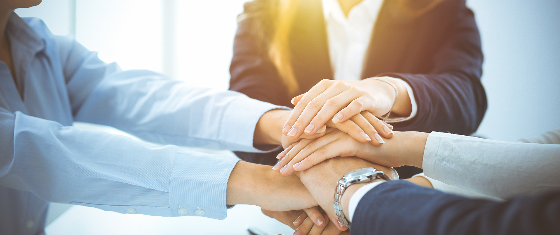 group of people with their hands stacked together