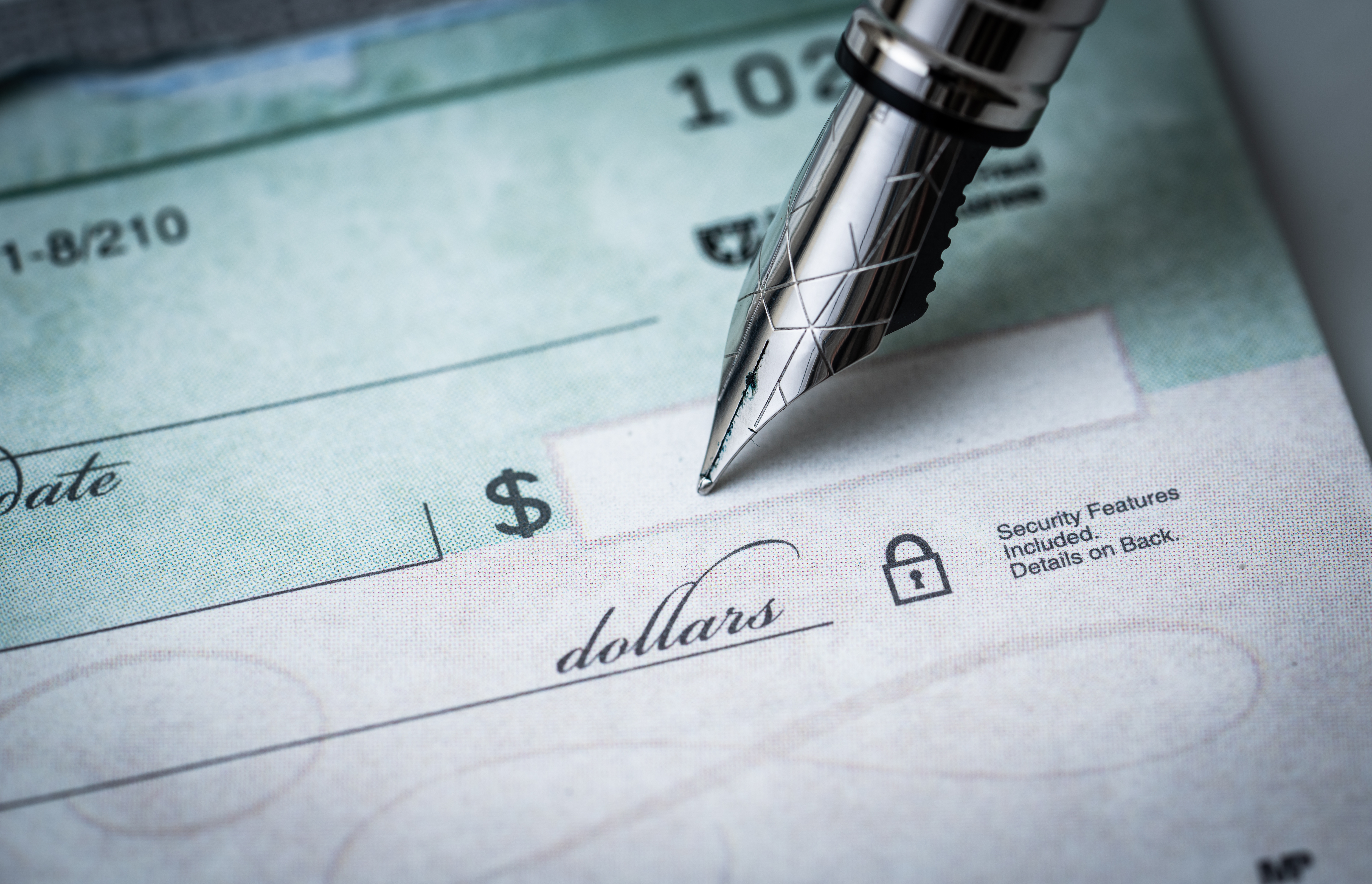 close up of pen on a blank check